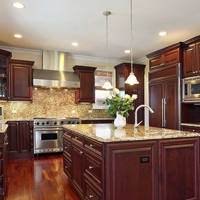 kitchen with dark wood cabinets, mosaic backsplash and granite countertops