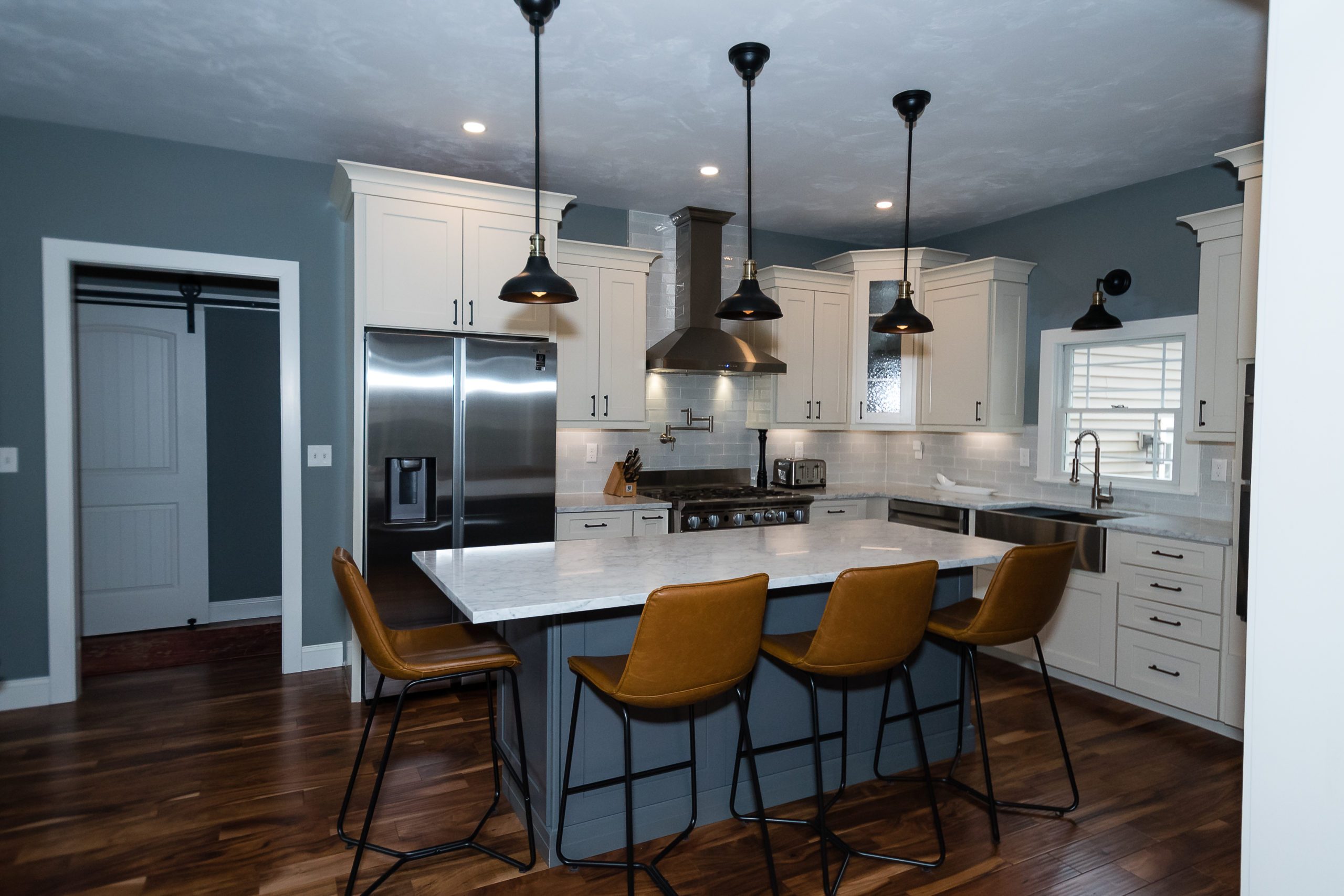 Kitchen with pendant lights and white countertop